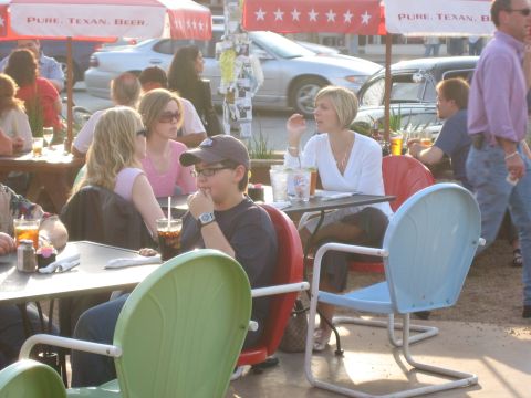 1996 Ford Bronco - Diners enjoy a meal at an outdoor patio, with vehicles parked nearby.
