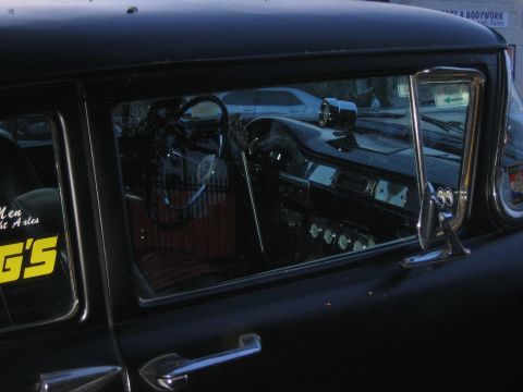 1996 Ford Bronco - The interior of a classic car is visible through the window, a vintage dashboard and steering wheel.