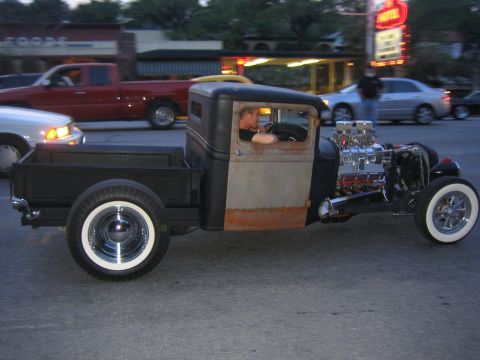 1996 Ford Bronco - A modified pickup truck with a large engine is seen driving on the street.