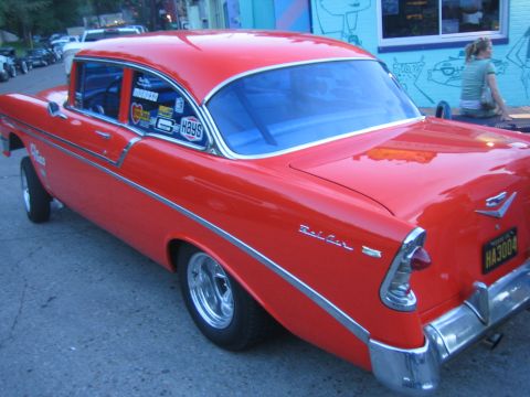 1996 Ford Bronco - Rear view of a red 1956 Chevrolet Bel Air coupe parked on a street.