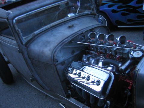 1996 Ford Bronco - Close-up of a hot rod's engine bay Ford Performance valve covers and exposed carburetors.