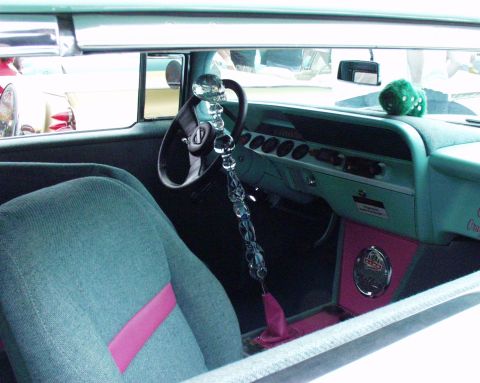 1996 Ford Bronco - Custom interior features a skull shifter, green fuzzy dice, and pink accents on the dashboard and seats.