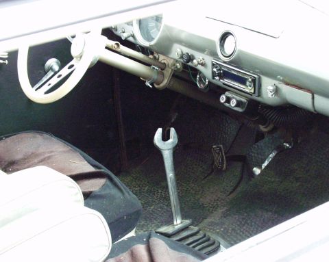 1996 Ford Bronco - Interior view of a vehicle's dashboard, showing the steering wheel, pedals, and a wrench.