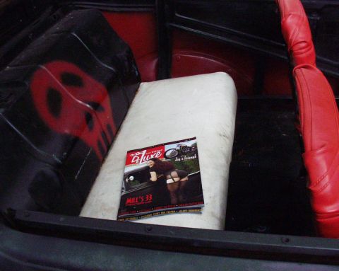1996 Ford Bronco - Vehicle interior with a magazine and a spray-painted skull graphic on the panel.