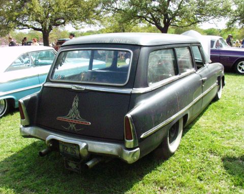 1996 Ford Bronco - Customized station wagon with pinstriping and dual exhaust, parked on grass with other vehicles.