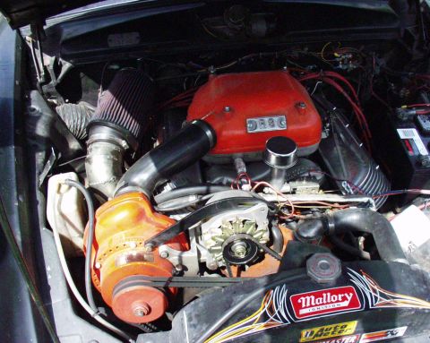 1996 Ford Bronco - Close-up view of a modified engine bay a prominent supercharger and various ignition components.