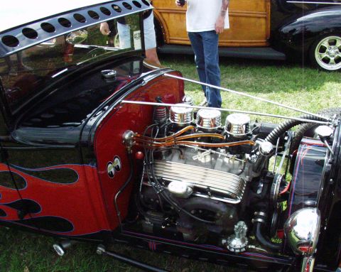1996 Ford Bronco - A custom hot rod features a prominent V8 engine with triple carburetors and flame graphics on the fender.