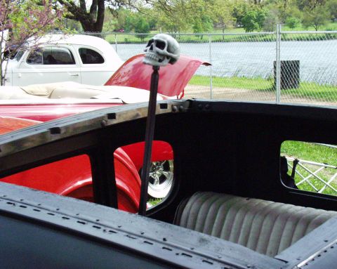1996 Ford Bronco - Interior view of a vintage car a skull shift knob and a glimpse of another vehicle.