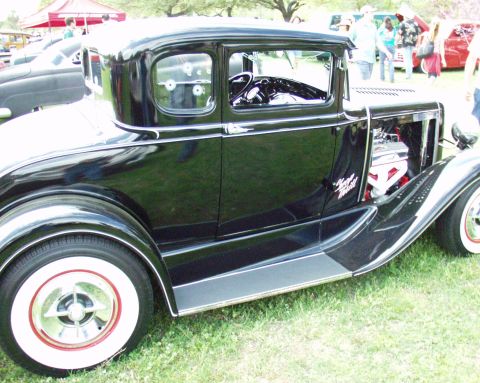 1996 Ford Bronco - Customized 1930s Ford coupe with a V8 engine on display at a car show.