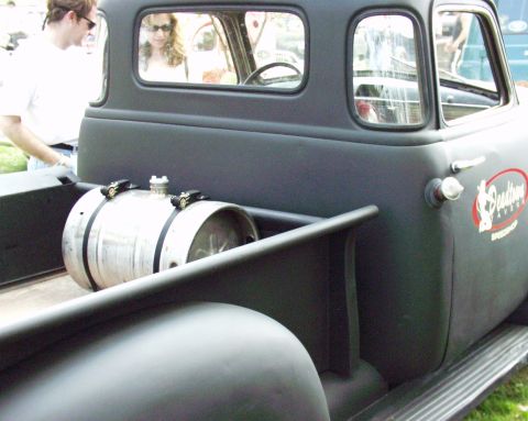 1996 Ford Bronco - A dark-colored pickup truck features a keg in its bed and a "Deadtime Speed Shop" logo on the door.