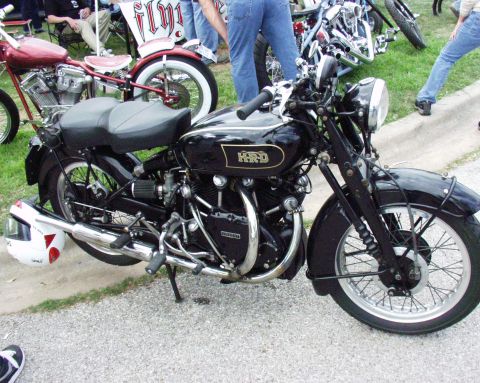 1996 Ford Bronco - A black HRD motorcycle is parked next to a red custom motorcycle.
