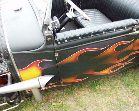 1996 Ford Bronco - This hot rod features custom flame paintwork on its side, along with a black interior and exposed exhaust system.