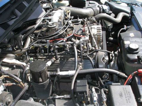 2001 Ford Crown Victoria - Detailed view of the engine compartment of a 2001 Ford Crown Victoria, showing various mechanical parts and electrical connections.