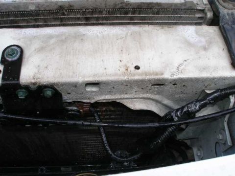 2001 Ford Crown Victoria - Close-up view of the radiator and wiring harness in the engine bay.
