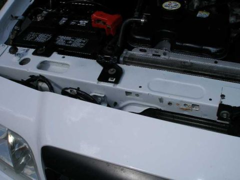 2001 Ford Crown Victoria - Engine bay of a 2001 Ford Crown Victoria, focusing on the battery and radiator area.