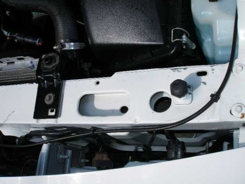 2001 Ford Crown Victoria - The photo shows a section of a vehicle's engine bay, focusing on hoses and mounting hardware.