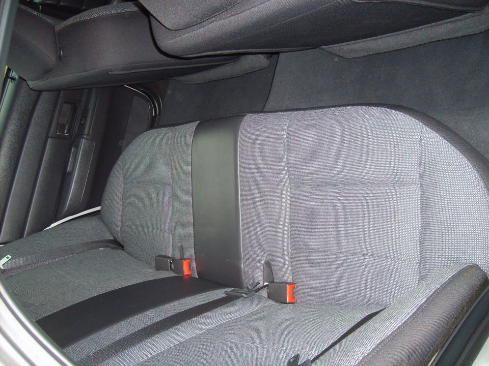 Gray fabric rear seat with black accents and seatbelts in a 2004 Ford Crown Victoria
