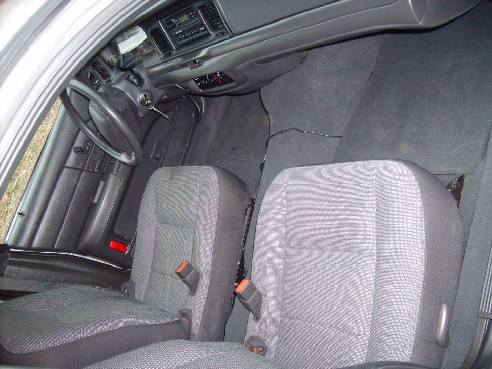 Interior view of a car showing front seats, dashboard, and steering wheel