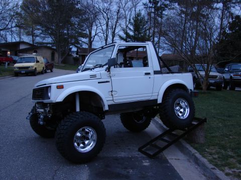 1990 Suzuki Samurai - This lifted 1990 Suzuki Samurai features prominent chrome wheels and an elevated suspension system.