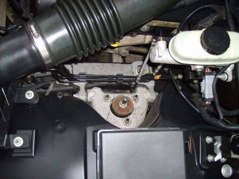 2004 Ford Crown Victoria - This image shows a section of a vehicle's engine bay, focusing on the brake fluid reservoir and air intake system.