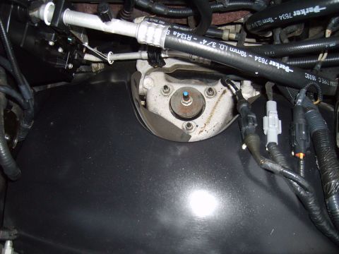 2004 Ford Crown Victoria - Close-up view of engine bay components, including hoses and wiring harnesses.