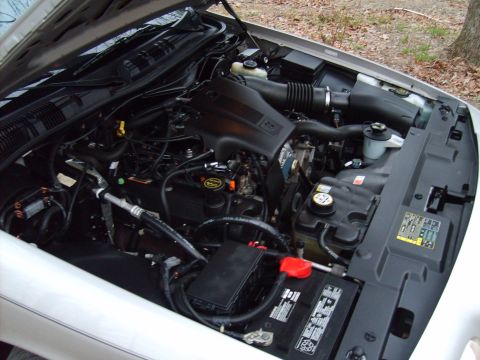 2004 Ford Crown Victoria - The engine bay of a 2004 Ford Crown Victoria is shown with the hood open.