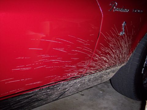1972 Ford Ranchero - Mud spray covers the side of a red vehicle, obscuring the paintwork.
