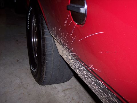 1972 Ford Ranchero - Mud splatters mark the side of this 1972 Ford Ranchero, showing the lower body panel and tire.