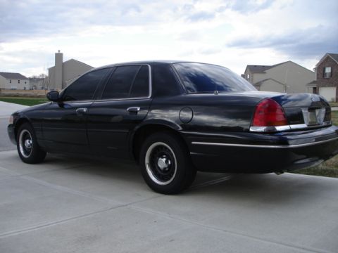 2001 Ford Crown Victoria - This black 2001 Ford Crown Victoria is shown from the rear quarter angle.