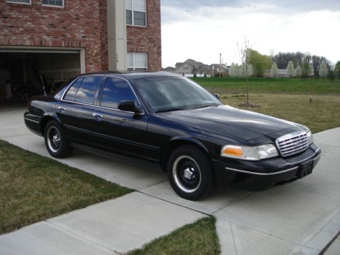 2001 Ford Crown Victoria - This 2001 Ford Crown Victoria is parked outside a brick building on a cloudy day.