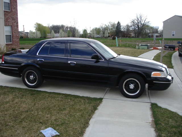 Black 2001 Ford Crown Victoria parked on a concrete driveway