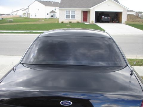 2001 Ford Crown Victoria - Rear view of a black 2001 Ford Crown Victoria parked on a suburban street.