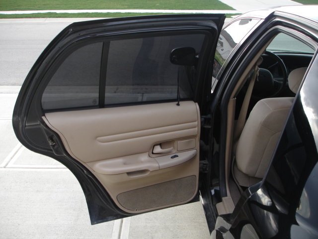 Interior shot of a 2001 Ford Crown Victoria, showing the front passenger seat and door panel