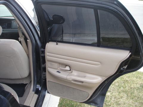 2001 Ford Crown Victoria - Interior view of a 2001 Ford Crown Victoria, showing the tan door panel and seat.