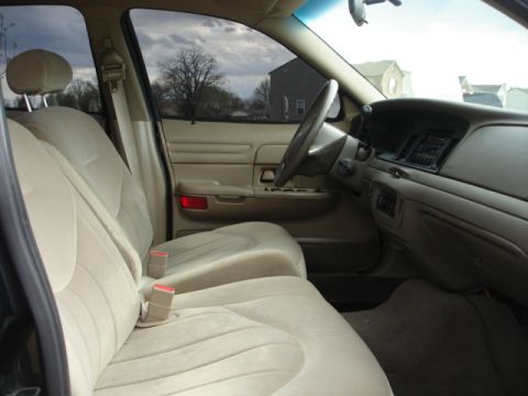 2001 Ford Crown Victoria - Interior view of a 2001 Ford Crown Victoria, highlighting the tan upholstery and dashboard details.