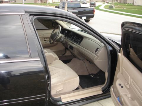 2001 Ford Crown Victoria - The interior of a 2001 Ford Crown Victoria is shown, with a black pickup truck in the background.
