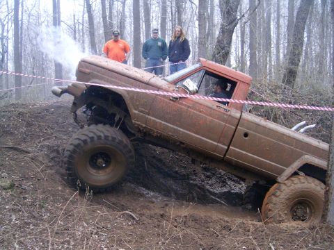 1979 Jeep J-10 - This 1979 Jeep J-10 navigates a challenging muddy incline during an off-road event.