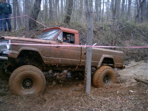 1979 Jeep J-10 - This 1979 Jeep J-10 navigates a muddy off-road course, its tires kicking up dirt.