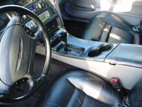 1995 Ford Thunderbird - The interior of a 1995 Ford Thunderbird features black leather seats and a detailed dashboard.