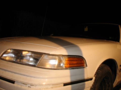 1992 Ford Crown Victoria - Front view of a white 1992 Ford Crown Victoria, highlighting its distinctive headlights and grille.