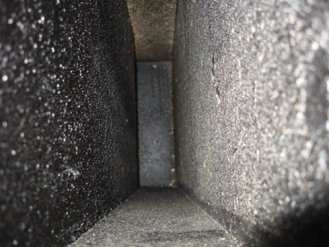 1992 Ford Crown Victoria - The interior of a dark, textured duct is visible, showing a rectangular opening receding into the distance.