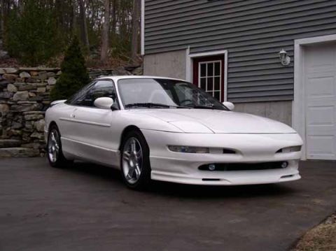 1996 Ford Probe - This 1996 Ford Probe GT is captured in a three-quarter front view, parked in a driveway next to a garage.