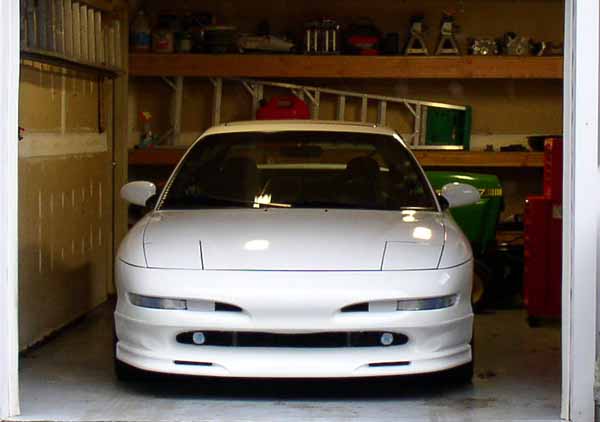 White 1996 Ford Probe parked in a garage, front view