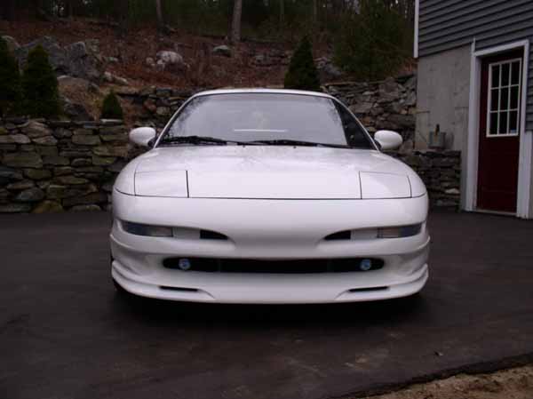 Front view of a white 1996 Ford Probe GT parked in a driveway
