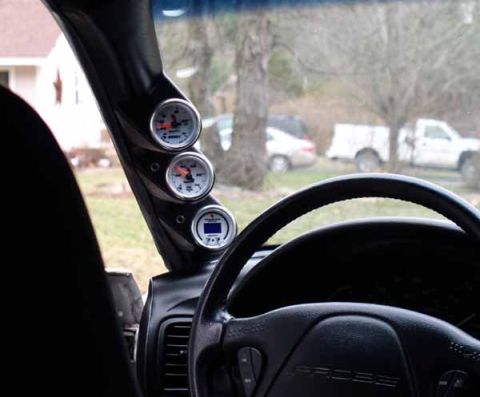 1996 Ford Probe - Interior view showing three gauges on the A-pillar and part of the steering wheel.