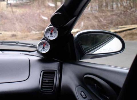 1996 Ford Probe - Aftermarket gauges are mounted on the A-pillar, showing readings from inside the vehicle.