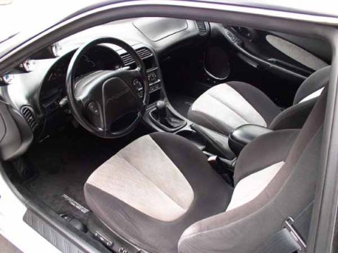 1996 Ford Probe - The interior of a 1996 Ford Probe GT is visible, with two-tone cloth seats and a black dashboard.