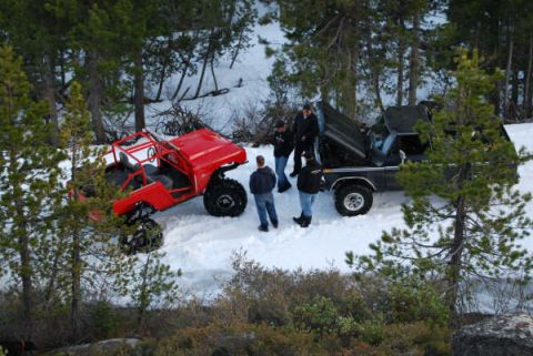 1989 Ford Bronco - Two vehicles and several people are gathered in a snowy, wooded area, with one vehicle appearing to be a modified off-road buggy and the ot…