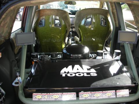1998 Ford Crown Victoria - Modified car interior with racing seats, screens, and tool storage is visible.