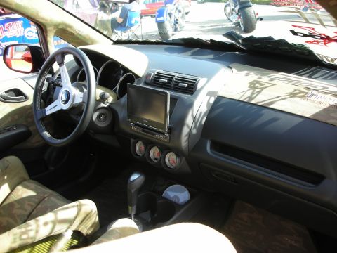 1998 Ford Crown Victoria - Customized car interior with aftermarket steering wheel and gauges, camouflage upholstery.